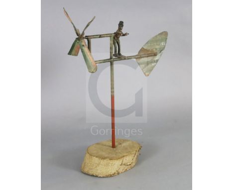 An American? painted wrought iron whirligig, on tree trunk plinth, H.39in.