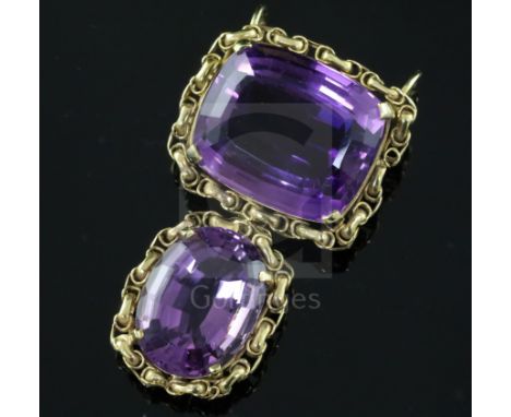 A gold and two stone amethyst set drop pendant, the oval cushion and round cut stones with ornate gold borders, 45mm.