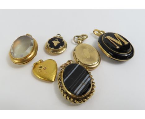 An oval engine turned pendant with locket compartment, acid tests as approximately 9ct gold, 2.3g gross; a heart shaped penda