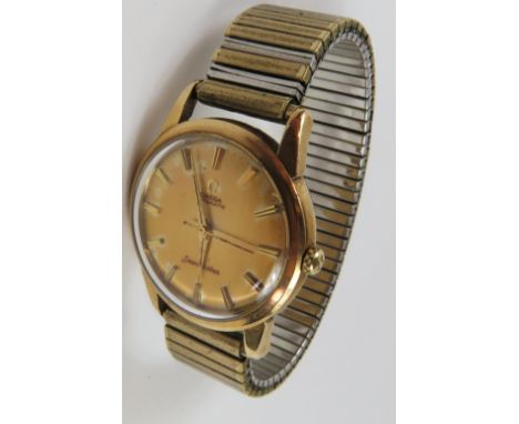 Omega - a gentleman's Seamaster Automatic, the round gold dial with gold baton hour markers and hands, in a 9ct gold case, on