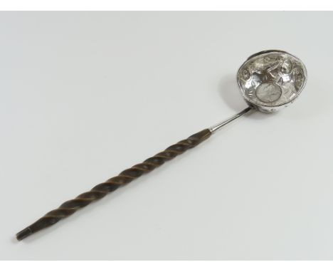 An angled toddy ladle with coin in bowl’s centre, the coin face of Queen Anne and likely dated between 1707 and 1714; the bow