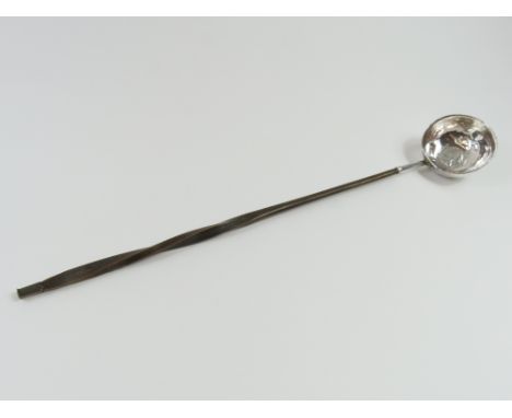 A toddy ladle with coin in bowl's centre; the coin face of Queen Anne and likely dated between 1707 and 1714; the bowl smooth