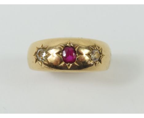 A Victorian gypsy ring, star set with a ruby and two old cut diamonds, the oval shaped ruby approximately 3.75mm x 3.1mm x 1.