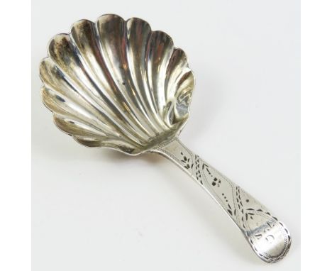 A Georgian silver caddy spoon, made by John Lambe in London 1793; the bowl shell shaped and thusly grooved; the handle decora