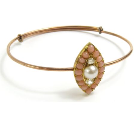 A Victorian bangle, the navette shaped head with a row of split coral surrounding a large split pearl and two old cut diamond