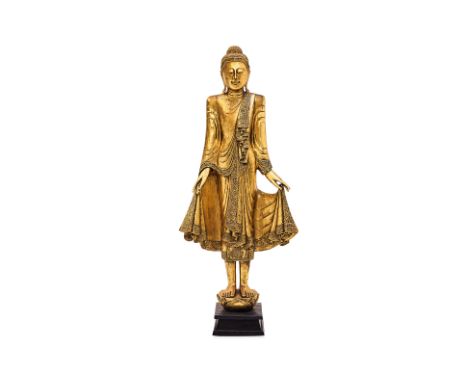 A LARGE THAI STATUE OF STANDING BUDDHA
Lacquered and gilt timber with inset coloured glass, Buddha standing with robe hanging