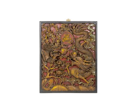 A LARGE CARVED WOOD DRAGON AND PHOENIX PANEL
The panel carved in high relief with a trailing dragon and a flying phoenix arou
