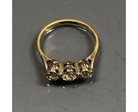 An 18 carat gold and platinum set three stone diamond ring, the centre stone approx 0.3 carat, flanked by two further stones 