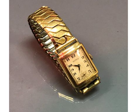 A 9 carat gold cased wristwatch, the movement by Rotary with rectangular silvered dial and Arabic numerals with subsidiary se