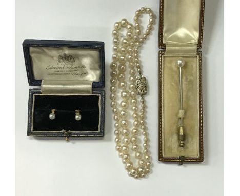 A graduated pearl single strand necklace with Art Deco style diamond encrusted clasp, the central stone approx 0.03 carat, to