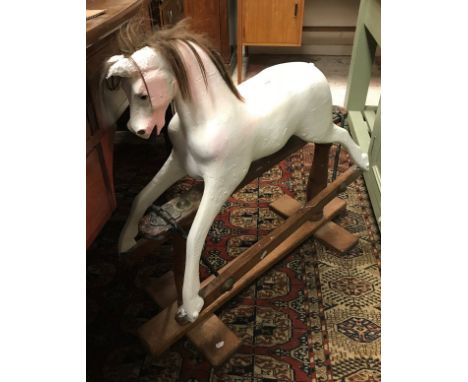 A vintage painted wooden rocking horse of small proportions, a Victorian brass and wirework sparkguard and a fender