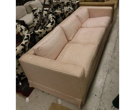 A modern three seater sofa with cream and red check upholstery 