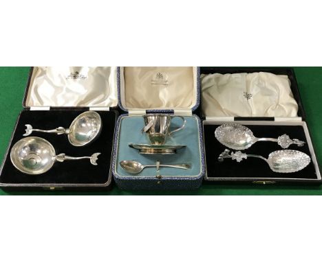 A silver egg cup and spoon, pair of exotic fish decorated handled spoons, Continental embossed silver / white metal spoons, s