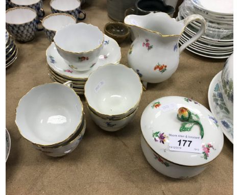 A Meissen floral decorated part tea service comprising five cups, five saucers, milk jug and lidded sugar bowl CONDITION REPO