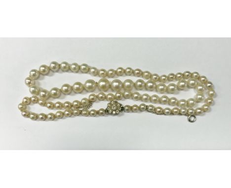 A graduated pearl single strand necklace with diamond flower head clasp, the centre stone approx 0.2 carat CONDITION REPORTS 