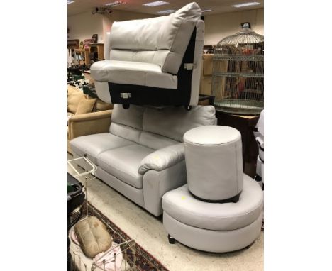 A modern pale grey upholstered corner sofa with pouffe and stool