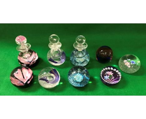 A collection of Caithness comprising a "Lilac Time" perfume bottle and paperweight, No'd. 45/150, a "Quintessence" perfume bo