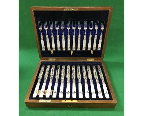 A set of twelve Edwardian silver and mother of pearl handled fruit knives and forks (by Atkin Brothers, Sheffield 1901), the 