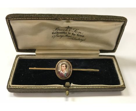 A gold and enamel bar brooch, the oval medallion decorated with portrait bust of Lord Byron (bar 15 carat, pin 9 carat)