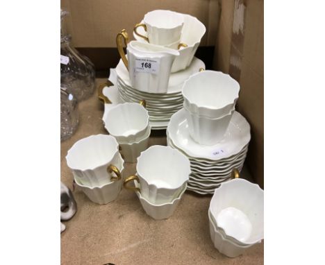 A Wedgwood part tea service with plain white ground and gilt decorated handles, comprising two serving plate, eleven tea plat