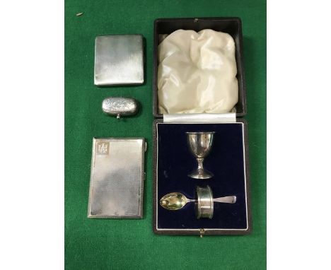 A silver Christening set of egg cup, napkin ring and spoon, sovereign case and two cigarette cases, 11.43 oz