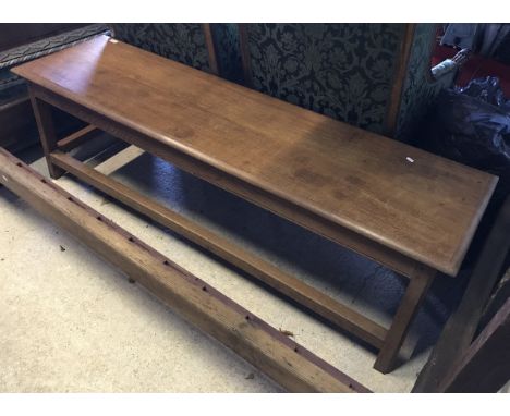 A 20th Century oak low side table/bench, the single piece moulded edge top on square chamfered supports united by stretchers 