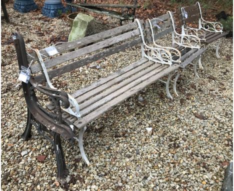 An early 20th Century wrought iron and slatted wooden three piece garden suite, comprising bench and two standard chairs, tog