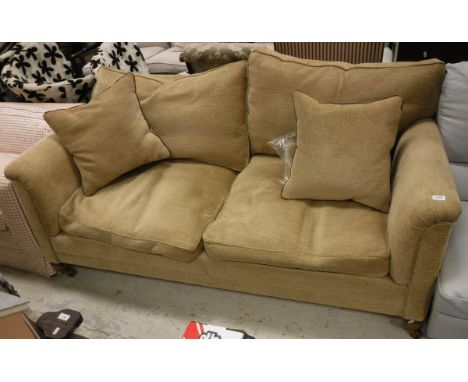 A sofa with mahogany legs and brass castors upholstered in Zoffany fabric