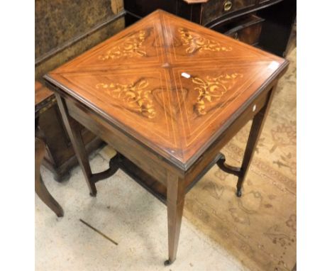 An Edwardian rosewood and inlaid envelope card table the base united by an under tier 