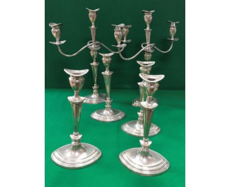 A set of six Edwardian silver table candlesticks of navette form, two with additional two branch three light candelabra fitti