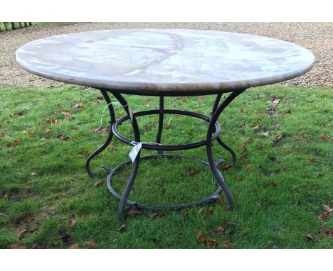 A wrought iron based marble top garden table