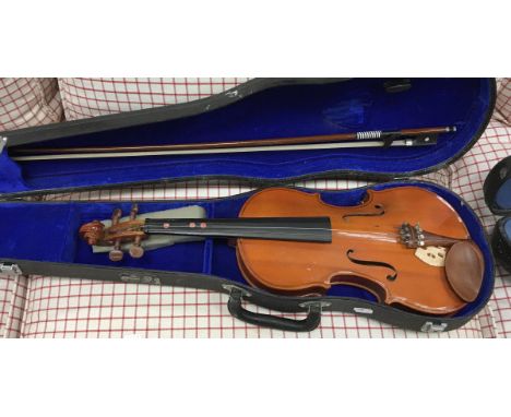 Three various student violins, together with cases and a Tonella accordion