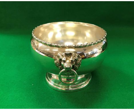 A George V silver pedestal bowl with beaded rim and heavy cast lion mask ring handles, raised on a circular foot (Birmingham 