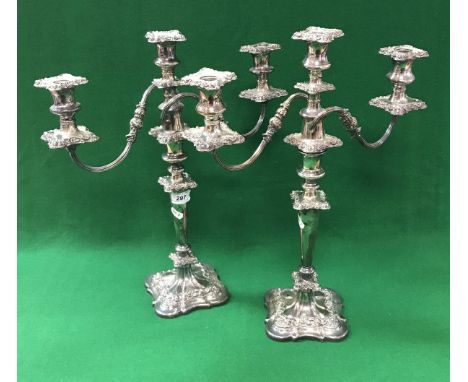 A pair of plated on copper two branch three light table candelabra