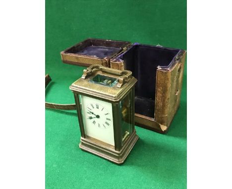 A 19th Century brass five glass carriage clock, the white enamel dial set with Roman numerals, housed in a leather carry case