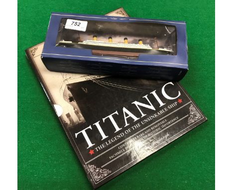 A modern model of Titanic in box, together with a centenary edition book and Cunard White Star teaspoon marked "Romney Plate 