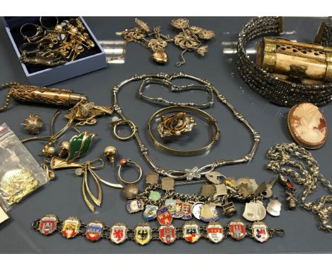 A jewellery bag and contents of various costume jewellery including necklaces, earrings, cameo brooch, Queen filigree cigaret