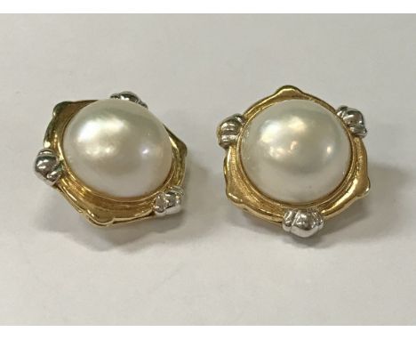 A pair of 14 carat gold mounted half cut pearl ear clips