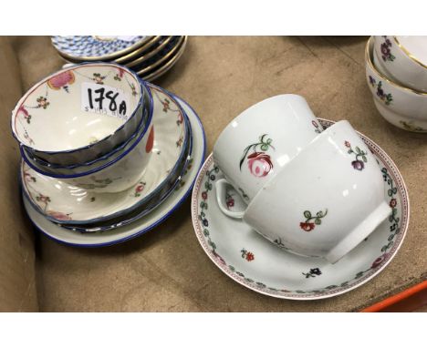 A pair of Newhall polychrome decorated pottery tea bowls and saucers with writhen decoration  together with a similar floral 
