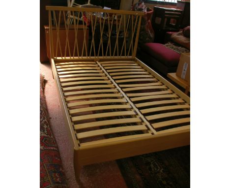 A modern 4ft 6 bed, the frame well made in light oak with crossover spindles, with mattress