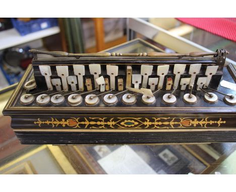 A mid-nineteenth century French accordion with twenty-four mother-of-pearl keys (marked with a makers’ label for C. Jordan 73