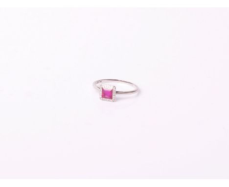 A ruby and diamond square cluster ring, centred with a square step-cut ruby approx. 0.70cts, rub-over set within an eight-cut