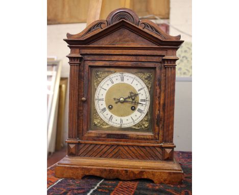 An Edwardian mantel clock with brass face and gong striking movement with key and pendulum in walnut caseh.40cm