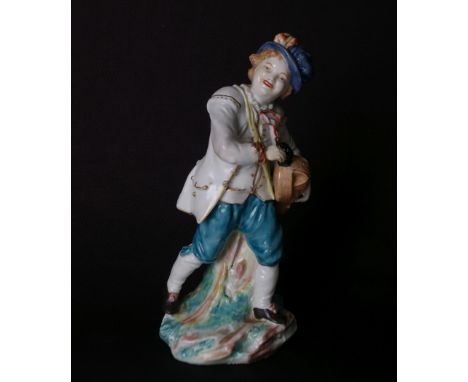 A rare Bristol porcelain figure: a smiling boy in hard paste porcelain well painted in enamels with turquoise breeches, yello