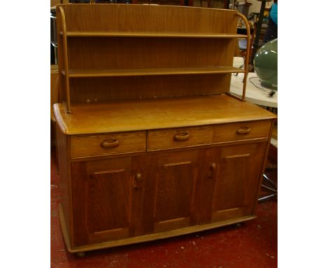 An Ercol style elm side unit with open shelf back 122cm wide 