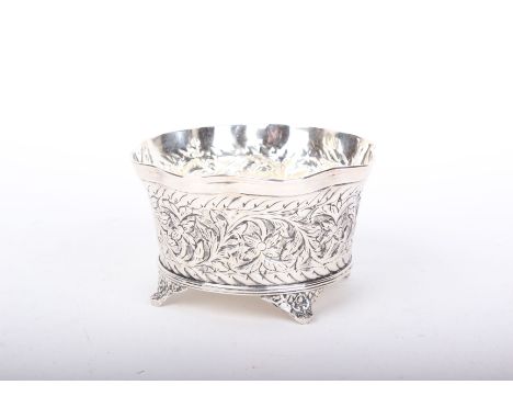 A Continental white metal bowl with wavy repousse decorated on four bracket feet. Diameter 15cm. Indistinct mark to one foot.