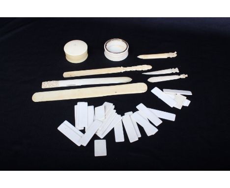An early 20th century ivory page marker with foliate carved top, five other markers/page turners (bone and ivory), two trinke