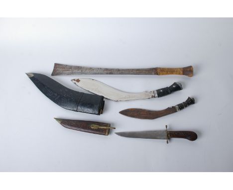An Indian sheath knife with carved wooded handle and sheath, brass fittings, and three other bush knives, one with leather sc