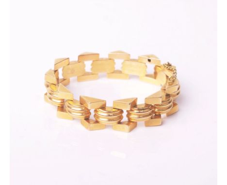A vintage Egyptian gold bracelet in the form of reeded arches with triangular borders, approx 17cm long