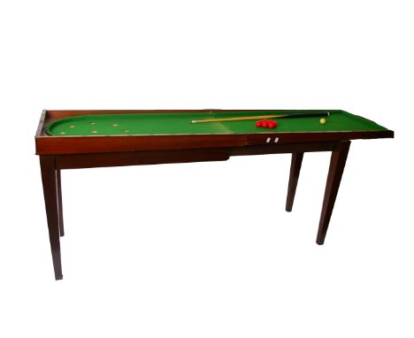 A late Victorian mahogany folding bagetelle table, circa 1900, the folding lid opening to baise playing surface with nine cup